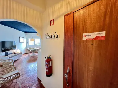 a living room with a fire extinguisher on the wall at Lagos Ocean Breeze 2 by Homing in Lagos