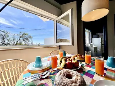a table with a plate of food and a window at Lagos Ocean Breeze 2 by Homing in Lagos