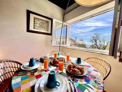 a table with plates of food on it with a window at Lagos Ocean Breeze 2 by Homing in Lagos