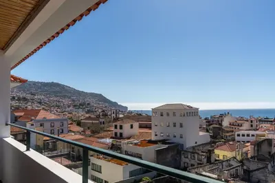a balcony with a view of the city at Casa Sta Clara by An Island Apart in Funchal