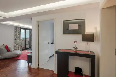 a bedroom with a bed and a desk and a chair at Casa Sta Clara by An Island Apart in Funchal