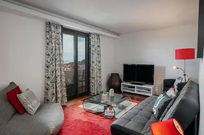 a living room with a couch and a glass table at Casa Sta Clara by An Island Apart in Funchal