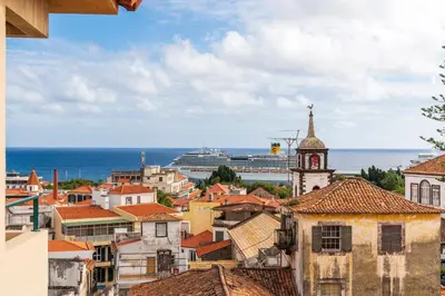 a bedroom with a bed with pillows and two lamps at Casa Sta Clara by An Island Apart in Funchal