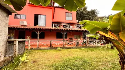 a living room with a bed and a table at Quinta Vista para o Pico in Faial