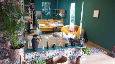 a living room with a yellow couch and a table at Quinta Vista para o Pico in Faial