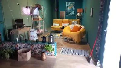 a living room with a yellow chair and a couch at Quinta Vista para o Pico in Faial