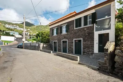 a brick building on the side of a road at Casa da Avó Paraíso 1 in Machico