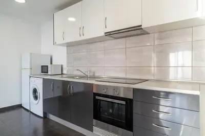 a kitchen with a sink and a stove at Casa Branca, in the Heart of Arco da Calheta in Arco da Calheta