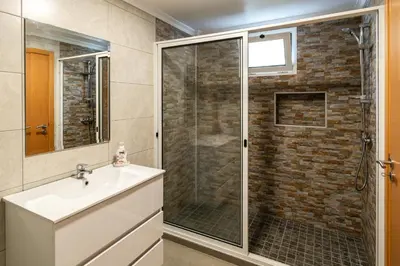 a bathroom with a shower and a sink at Casa Branca, in the Heart of Arco da Calheta in Arco da Calheta