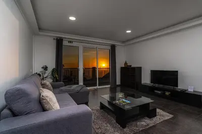 a living room with a couch and a coffee table at Casa Branca, in the Heart of Arco da Calheta in Arco da Calheta