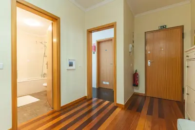 a hallway with a door and a bathroom at Quintas Village AY by Atlantic Holiday in Caniço