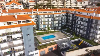 a swimming pool in front of a building at Quintas Village AY by Atlantic Holiday in Caniço