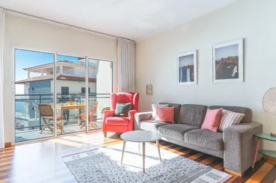 a living room with a couch and a table at Quintas Village AY by Atlantic Holiday in Caniço