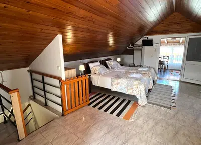 a kitchen with a counter with a microwave and a table at Sea & Mountain View Lombo de Cima House BBQ & Wifi in Santana