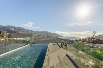 a swimming pool on the roof of a house at Infinity Haven in Funchal