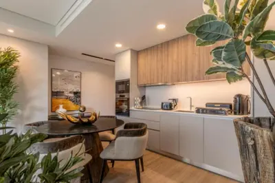 a kitchen and living room with a table and chairs at Infinity Haven in Funchal