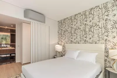 a bedroom with a bed and a large window at Infinity Haven in Funchal