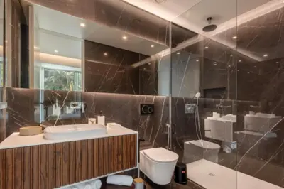 a bathroom with a sink and a toilet and a mirror at Infinity Haven in Funchal