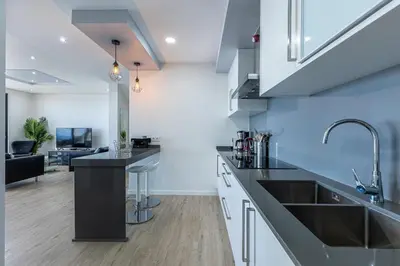 a kitchen with a sink and a counter top at Ocean and Palms in Arco da Calheta