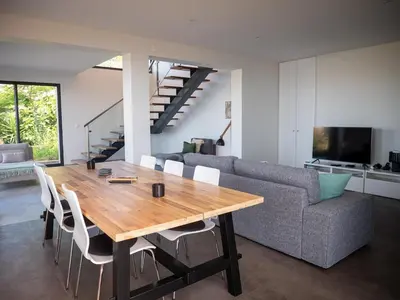 a living room with a wooden table and a couch at Ocean's 13 in Ponta do Sol