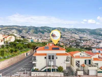 a yellow balloon on top of a building with a city at Avista Navios Holiday Home - Sea View & Free Parking in Funchal in Funchal