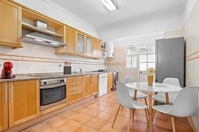 a kitchen with a white table and chairs and a table and a table at Avista Navios Holiday Home - Sea View & Free Parking in Funchal in Funchal