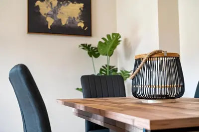 a wooden table with chairs and a basket on top at Avista Navios Holiday Home - Sea View & Free Parking in Funchal in Funchal