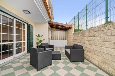 a patio with two chairs and a wall at Avista Navios Holiday Home - Sea View & Free Parking in Funchal in Funchal