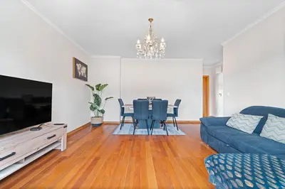 a living room with a blue couch and a table at Avista Navios Holiday Home - Sea View & Free Parking in Funchal in Funchal