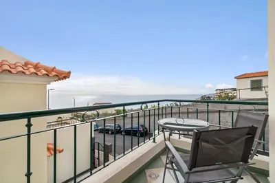 a balcony with a table and a view of the ocean at Avista Navios Holiday Home - Sea View & Free Parking in Funchal in Funchal
