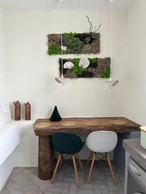 a kitchen with a wooden table and two chairs at Casa de basalto in Caniço