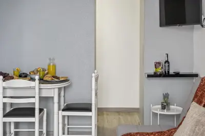 a small kitchen with a table and chairs at Seaside Charm II in Câmara de Lobos