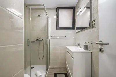 a bathroom with a shower and a toilet and a sink at Seaside Charm II in Câmara de Lobos