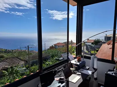 an office with a view of the ocean at Sally's Loft - Penthouse - Honeymoon suite in Ponta do Sol