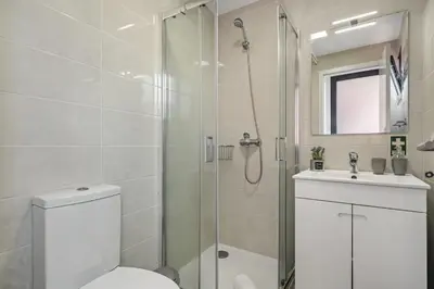 a bathroom with a shower and a toilet and a sink at Seaside Charm I in Câmara de Lobos