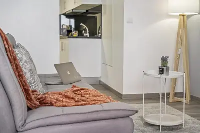 a living room with a couch with a laptop on it at Seaside Charm I in Câmara de Lobos