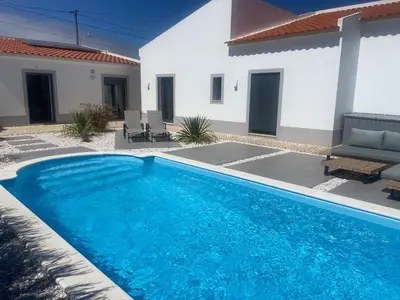a swimming pool in front of a house at Modern house with private Pool in Sagres