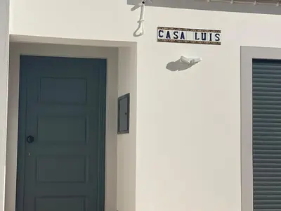 a door and a sign that reads casas units on a wall at Modern house with private Pool in Sagres