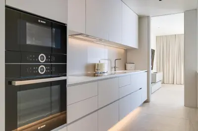 a kitchen with white cabinets and a microwave at RJS Savoy Monumentalis by Holiday Rental Madeira in Funchal
