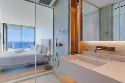 a bathroom with a shower and a sink and a bed at RJS Savoy Monumentalis by Holiday Rental Madeira in Funchal
