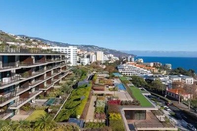 arial view of a city with buildings and the ocean at RJS Savoy Monumentalis by Holiday Rental Madeira in Funchal