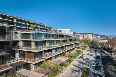 an apartment building with balconies and a street at RJS Savoy Monumentalis by Holiday Rental Madeira in Funchal