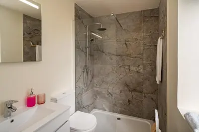 a bathroom with a shower and a toilet and a sink at Madeira Friendly Guest House by An Island Apart in Funchal