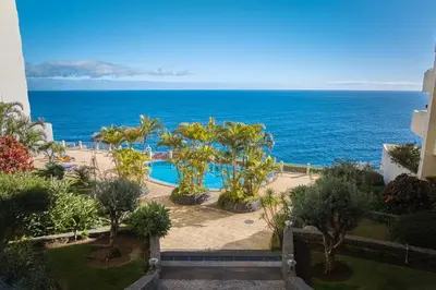 a view of the ocean from the balcony of a resort at IVIS Home By Holiday Rental Madeira in Funchal