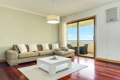 a living room with a couch and a table at IVIS Home By Holiday Rental Madeira in Funchal