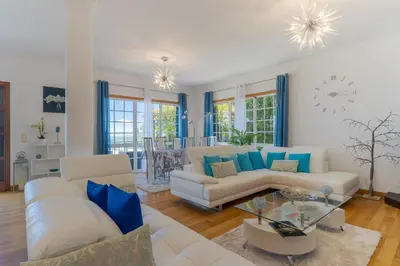 a living room with two couches and a table at Villa Black Rock by Holiday Rental Madeira in Santa Cruz