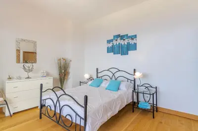 a bedroom with a bed with blue pillows at Villa Black Rock by Holiday Rental Madeira in Santa Cruz