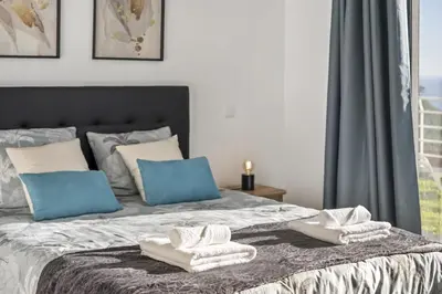 a bedroom with a bed with towels on it at Villa Soleil by Homie in Arco da Calheta