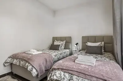 two beds sitting next to each other in a bedroom at Villa Soleil by Homie in Arco da Calheta