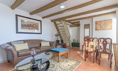 a bedroom with a white bed and a window at Vila Pitaias in Estreito da Calheta